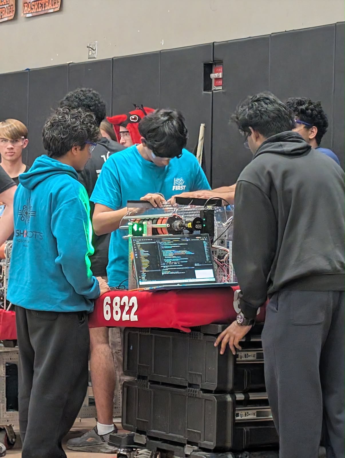 The Shishkabots working on their robot in the competition pit