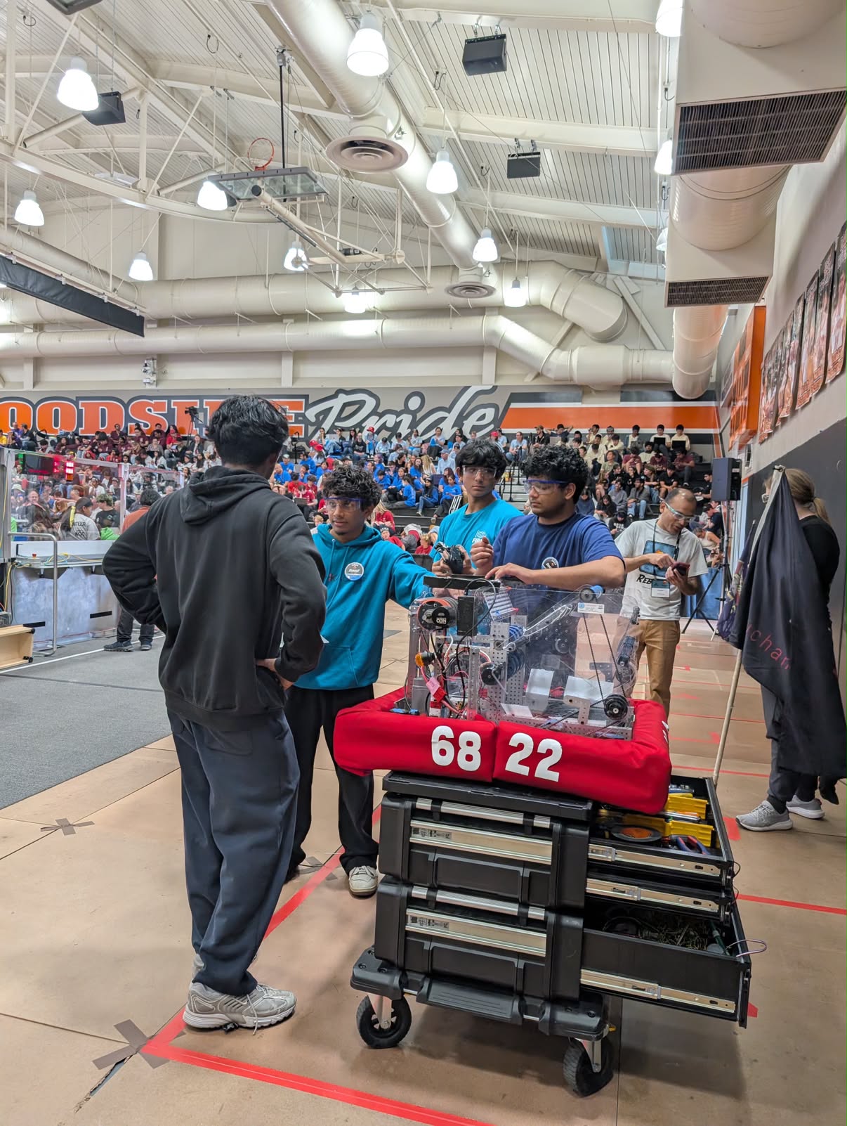 The Shishkabots preparing their robot beside the competition field