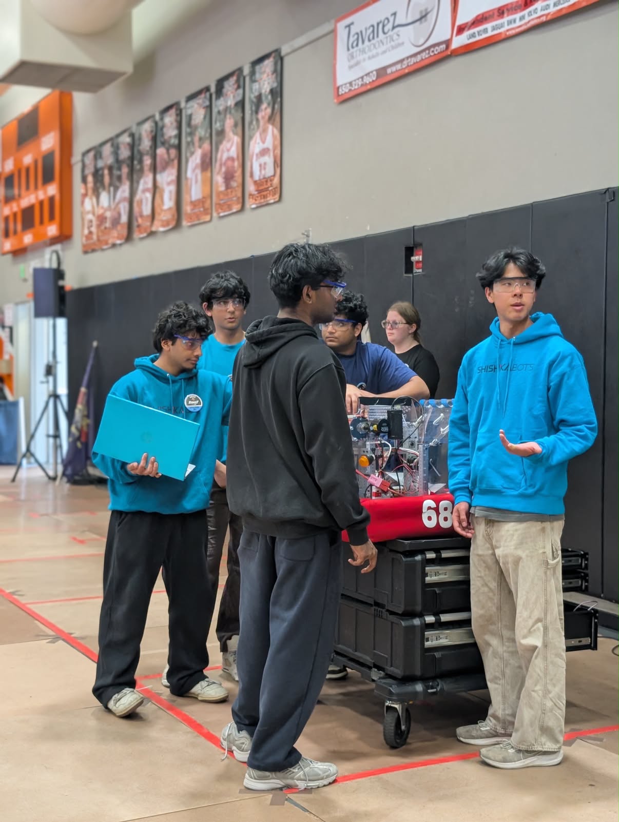 Shishkabots team members gathered around their competition robot