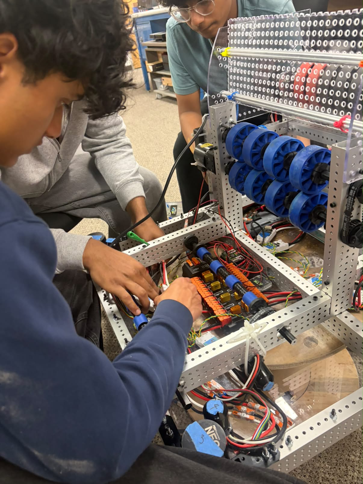 The Shishkabots assembling their competition robot